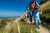 Group Of Adults With Boy, Walking Along Path At Devil's Dyke Near Brighton