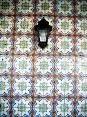 Lantern In Front Of Wall Covered With Floral Pattern