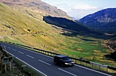 Car On Paved Road Through Mountains, Blurred Motion