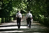 Zwei alte Männer gehen im Park spazieren, Rückansicht, Königspalast (Palacio Real), Aranjuez, Spanien