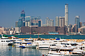 Boats At Causeway With City Skyline