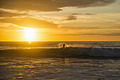 Surfer Riding A Wave At Sunset, Dreamland Beach; Bali Island, Indonesia