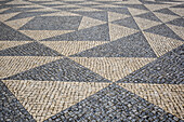 Traditional tiling in patterns on the ground; Lisbon, Portugal