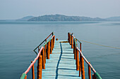 A dock leading out to the tranquil waters in the Bay of Bengal; Andaman Islands, India