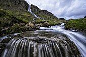 Motion blur of flowing water at a waterfall near Djupavik; West Fjords, Iceland