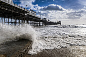 Brighton Palace Pier with waves crashing onto shore; Brighton, Sussex, England