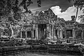 Monochrome facade of Preah Khan in trees, Angkor Wat; Siem Reap, Siem Reap Province, Cambodia