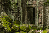 Statues and fallen rocks by temple doorway, Ta Prohm, Angkor Wat; Siem Reap, Siem Reap Province, Cambodia