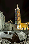 Roman ruins and the Tower of St Anastasia's Cathedral at night; Zadar, Croatia