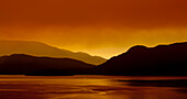 Gibsons Landing and the sky glowing red with forest fire smoke at sunrise, Sunshine Coast; British Columbia, Canada