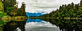 Mirror image of landscape into Lake Matheson; South Island, New Zealand