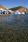 Klima village with white houses and colourful accents along the water's edge; Klima, Milos Island, Cyclades, Greece