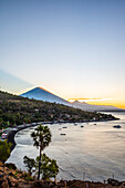 Amed Beach with Mount Agung in the background at sunset; Bali, Indonesia