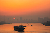 Misty sunrise on a river in China; Shanghai, Shanghai, China