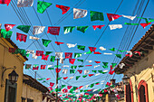 Garlands strung across a street between buildings; San Cristobal de las Casas, Chiapas, Mexico