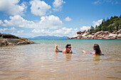 Alma Bay is one of the many beautiful beaches on Magnetic Island. A couple enjoys the refreshing beautiful clear waters; Magnetic Island, Queensland, Australia