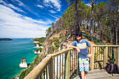 A man relaxes at a Haihe viewpoint, Cathedral Cove, Coromandel Peninsula, in New Zealand; New Zealand