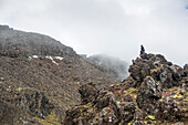 A man admires the view in the Tongariro National Park; Manawatu-Wanganui, New Zealand