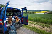 A quick rest stop along the road in Czech Republic. Girls relax in the back of the vehicle; Czech Republic