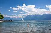 A man goes for a morning swim in the Swiss city of Lutry; Lutry, Vaud, Switzerland