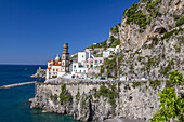 The fishing village of Atrani, along the Amalfi Coast with the domed church and bell tower of the Collegiata di Santa Maria Maddalena on the rocky cliffs of the Sorrentine Peninsula in Campania; Atrani, Province of Salerno, Italy