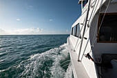 Close-up of the the port side of an offshore sports fishing boat headed out to sea; Key West, Florida, United States of America