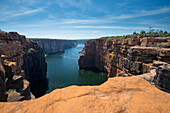 Springtime at the lookout at the King George River waterfall in the Kimberley Region, looking through the sandstone cliffs overlooking the river below; Western Australia, Australia