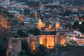 St Nicholas Church, illuminated at dusk on the lower court of the ancient walled fortress of Narikala situated on the hillside above the Kura (Mtkvari River) at dusk; Tbilisi, Georgia