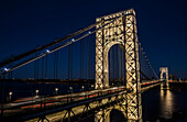 George Washington Bridge (specially lit for Martin Luther King Jr. Day) crossing the Hudson River to Manhattan at night; Fort Lee, New Jersey, United States of America
