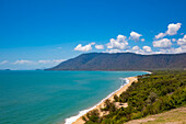 Scenic view overlooking the sandy beach, mountains and vegetation where the Daintree Rainforest meets the Coral Sea on the Pacific Ocean Coast in Eastern Kuku Yalanji; Daintree, Queensland, Australia