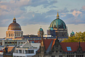 The patinated Berliner Dom and the dome of the reconstructed Berlin Palace (Humboldt Forum) on Museum Island in the Historic Centre of Berlin at sunset; Berlin, Germany
