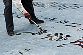 Painting Calligraphy On Pavement At The Temple Of Heaven; Beijing, China