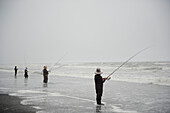 Men Fishing Along The Coast; Washington United States Of America
