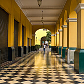 A Man Walks Down The Corridor In The Historic Centre Of Lima; Lima Peru