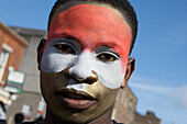 Eine Person mit geschminktem Gesicht bei der St. Patrick's Day Parade; Dublin Irland