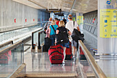 Tourists With Luggage Heading For The Departure Lounge At Malaga Airport; Malaga Province Costa Del Sol Spain