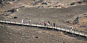 People Walking On A Wooden Boardwalk; Bartolome Island Galapagos Equador