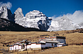 China, Jade Dragon Snow Mountain in background; Lijiang, Old buddhist temple on Yak meadow
