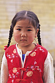 Mongolia, Girl wearing red vest; Ulaanbaatar