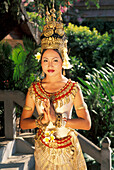 Cambodia, Woman in traditional dancing costume standing on steps; Siem Reap