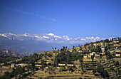 Nepal, Village Near Nagarkot, Distant Overview Of Terraces, Himalayan Mountains In Background.