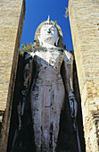 Thailand, Sukhotha, Low angle view of Standing Stone Statue Between Pillars; Wat Mahathat