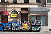 Five Garbage Dumpsters covered in Graffiti along Curb, Koreatown, Los Angeles, California, USA