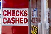 "Checks Cashed" Sign on Wall of Financial Services Business