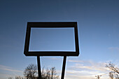 Low Angle View of Old Metal Sign Frame with No Message against Blue Sky