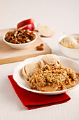 Apple crumble with pecan nuts and ice cream