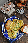 Onion omelette with fresh herbs and buttered toast