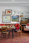 Cozy dining area with wooden table, picture gallery and piano