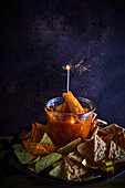 Nachos and tortilla chips with tomato salsa