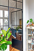 Stylish interior in old building with glass door and houseplants